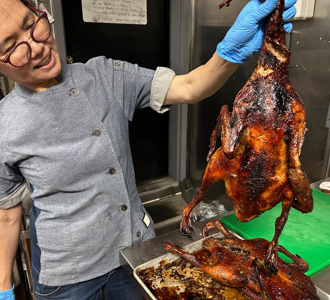 Chef Lee examines her freshly roasted ducks at Sanook Soi 38.